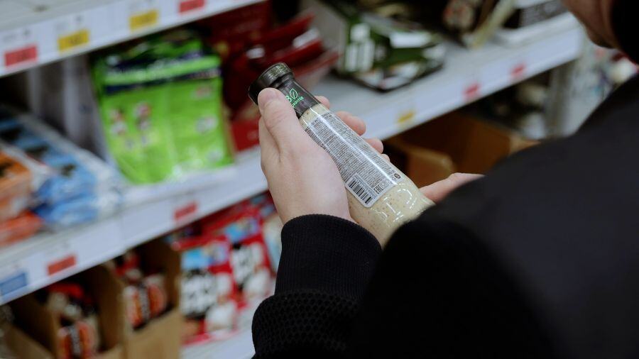 Image of a consumer reviewing a packaged food label