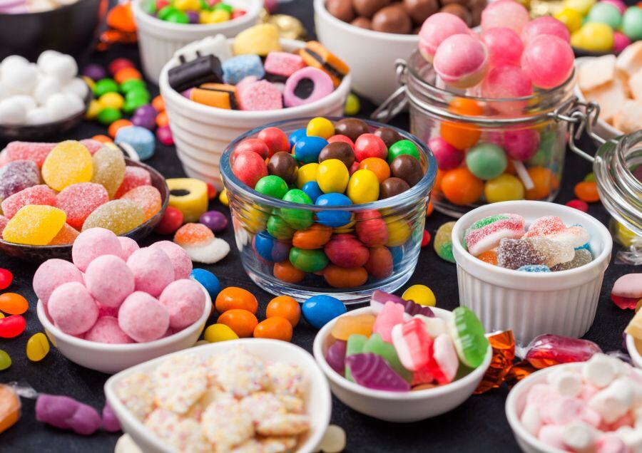 A tabletop with bowls of snacks and sweet snacks